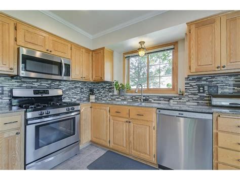 gray kitchen cabinets with stainless steel appliances pine walls|light gray cabinet walls.